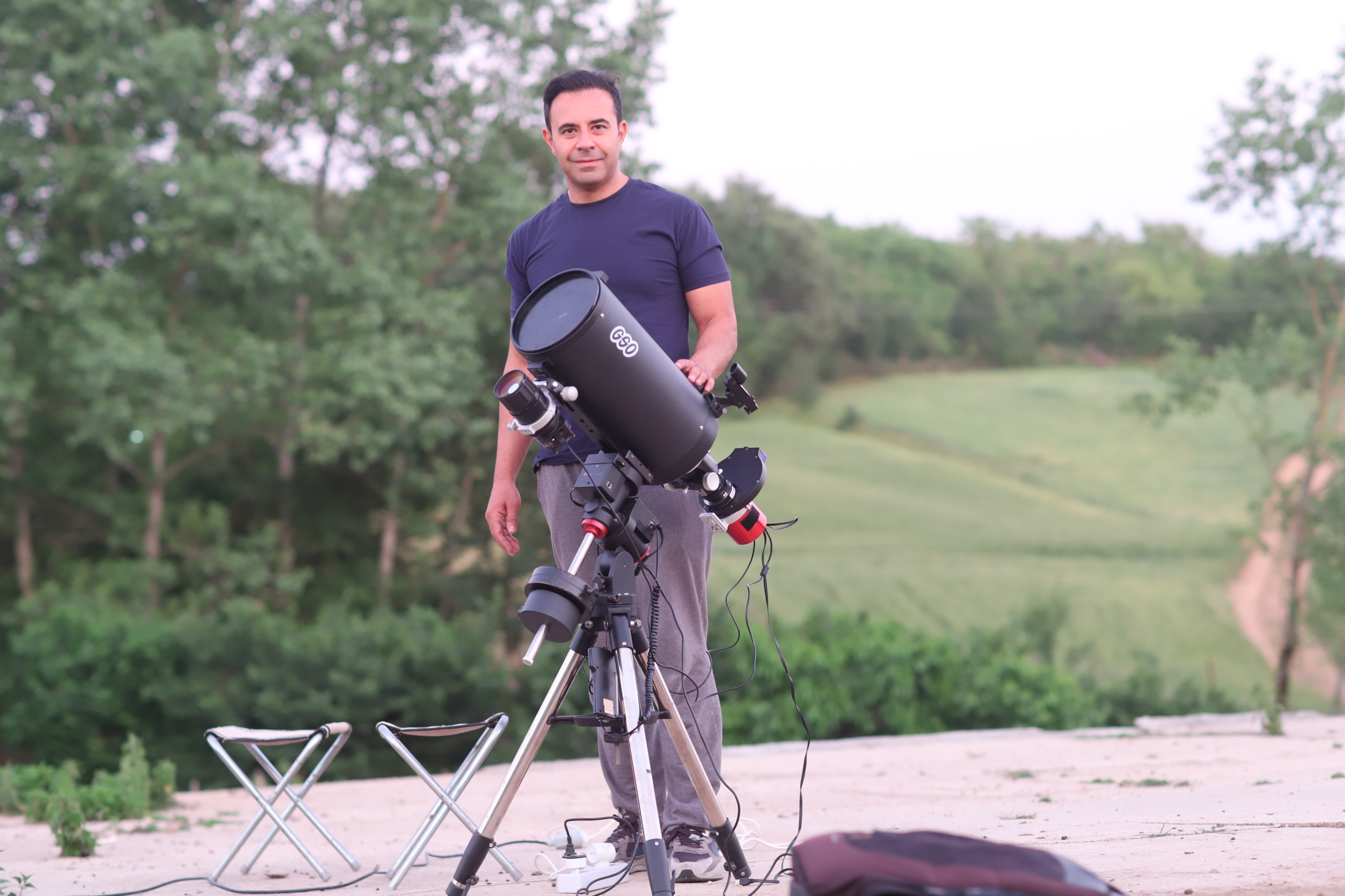 Dr. Shafe standing by his powerful telescope for astrophotography